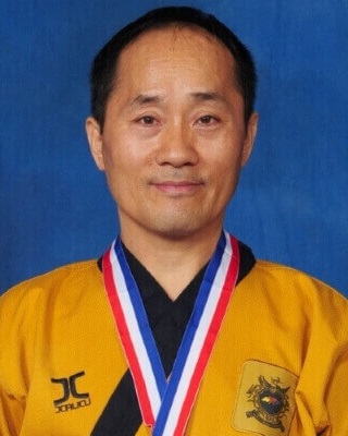 Headshot of Grandmaster Lee wearing a medal from a competition