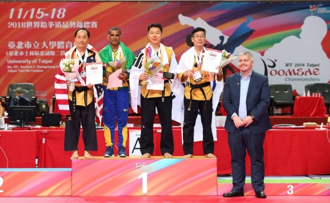 Silver Medalist Grandmaster Lee (Left) with three other competitors (Right) during 2018 Taekwondo World Championship in Taipei, Taiwan.