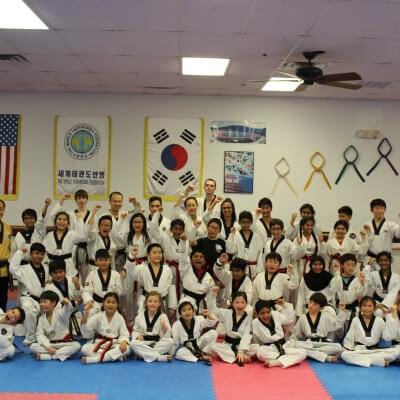 A group of black belt students cheering